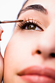 Extreme close up of a woman applying eyeshadow