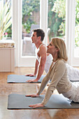 Man and woman practicing yoga