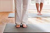 Two people legs and feet during a yoga practice