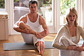 Man and woman practicing yoga