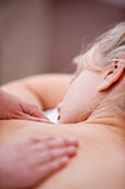 Close up of woman lying on stomach receiving a massage