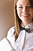 Smiling waitress holding a wine glass