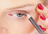 Close-up View of Woman Using Eye Pencil