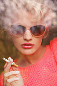 Young Woman Smoking Cigarette Behind Pane of Glass