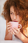 Close up of Young Woman Sipping Hot Drink