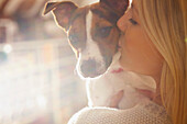 Young Woman Kissing Dog