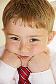 Portrait of Young Boy with Hands on Chin