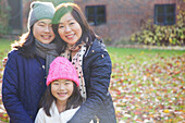 Mother and her Daughters Smiling Outdoors