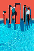 View from above red diving platforms and diving boards above sunny blue swimming pool