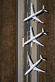 View from above airplanes parked on sunny airport runway