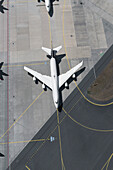 View from above airplane waiting on sunny airport runway