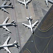 View from above airplanes on sunny airport tarmac and runway