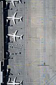 View from above airplanes parked at airport departure gates on tarmac