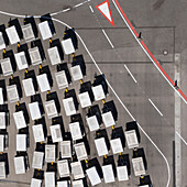 View from above luggage carts on sunny airport tarmac