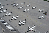 High angle view airplanes parked on sunny airport tarmac