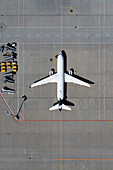 View from above airplane parked on sunny airport tarmac