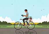 Man with stack of books reading and riding bicycle in sunny, idyllic countryside