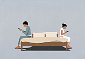 Distracted couple using smart phones back to back on bed