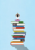 Woman meditating on large stack of books