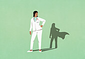 Superhero shadow of female doctor on green background