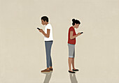 Couple standing back to back, using smart phones on beige background