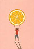 Happy girl holding large orange slice overhead on pink background