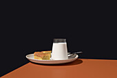Milk glass and pasiego sponge cake on a plate