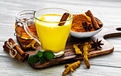 Yellow turmeric latte drink. Golden milk with cinnamon and turmeric