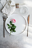 Elegant table setting with rose and minimalist design