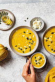 Creamy autumn pumpkin soup with feta and seeds
