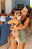 Woman holding a dog at a healthy food retreat