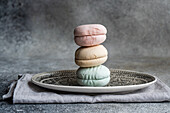 Pastel-coloured Zephyr sweets stacked on a decorative plate