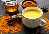 Yellow turmeric latte drink. Golden milk with cinnamon and turmeric