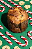Christmas treats on a green background with panettone and candy canes