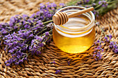 Jar with honey and fresh lavender flowers