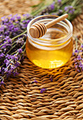 Jar with honey and fresh lavender flowers