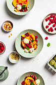 Fresh peaches with vanilla ice cream and berries on ceramic plates