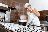 Baker cutting out biscuits in the kitchen