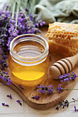 Jar with honey and fresh lavender flowers