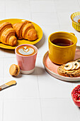 Colourful breakfast buffet with pastries, tea and latte
