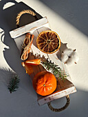 Cozy scene with mandarins and dried fruit slices on wooden tray