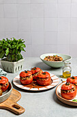 Roasted stuffed tomatoes with herbs and nuts on ceramic plates