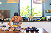 Woman preparing vegan dishes in a kitchen at the retreat