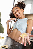 Young girl has fun baking biscuits in the kitchen