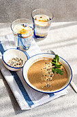 Healthy dinner set featuring mushroom cream soup and apple water