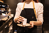 Barista serves chocolate drink