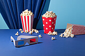 Cinema evening with colourful popcorn buckets and 3D glasses