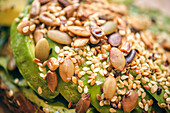 Avocado toast topped with a mix of seeds and nuts