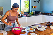 Woman prepares vegan meals in a bright kitchen