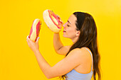Playful woman with a huge decorative donut
